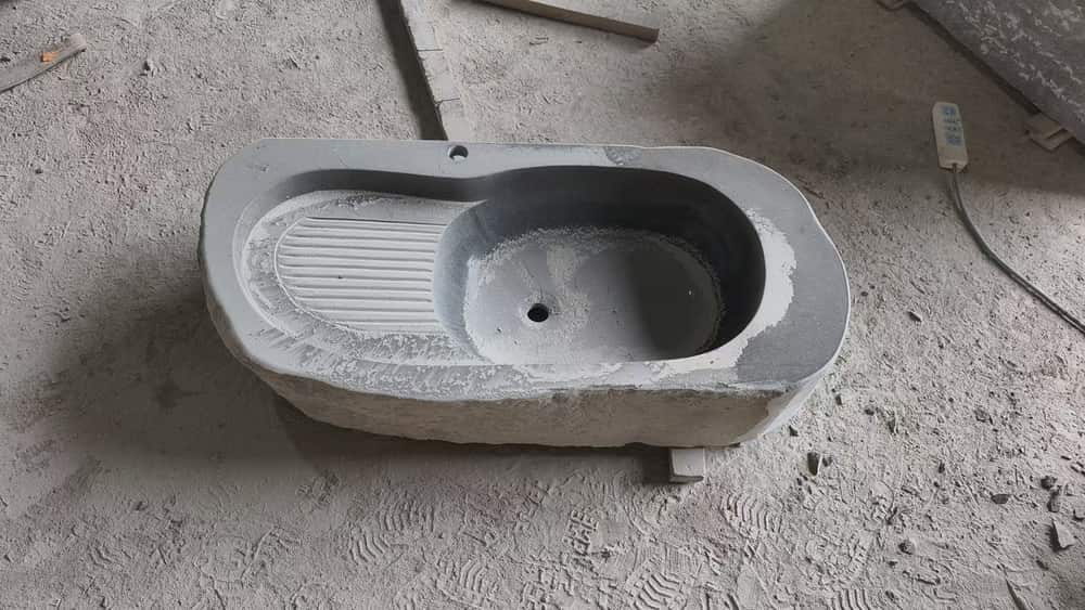 Rectangular natural stone basin with integrated drainboard viewed from above