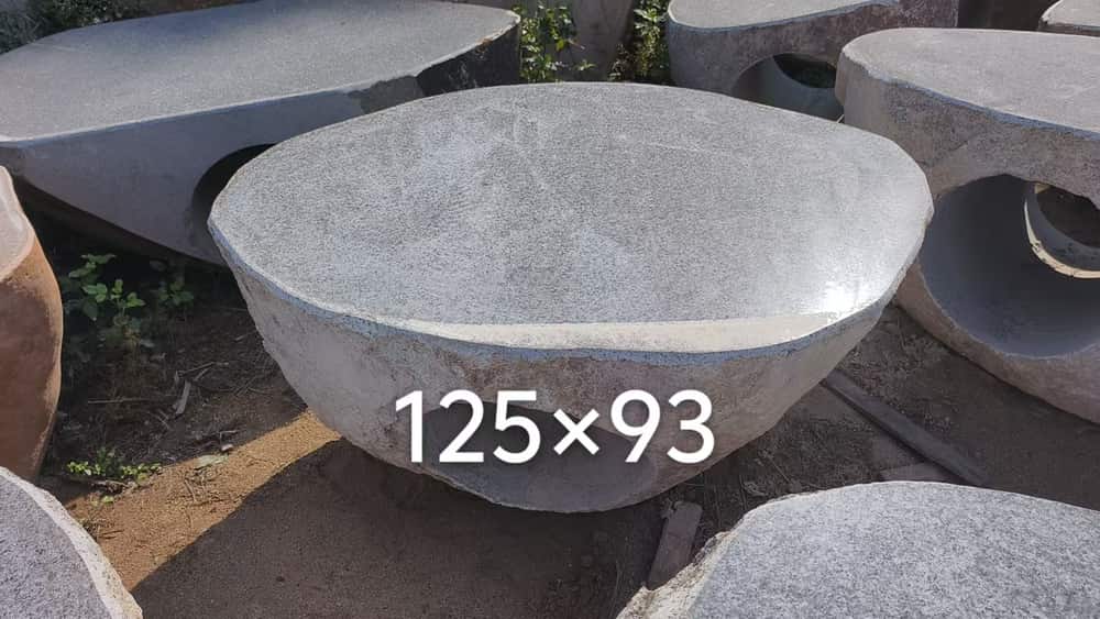 Large round natural stone wash basin photographed in the workshop
