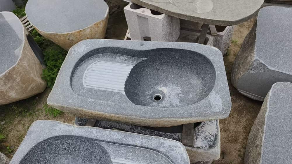 Rectangular natural stone basin with integrated drainboard and drain opening