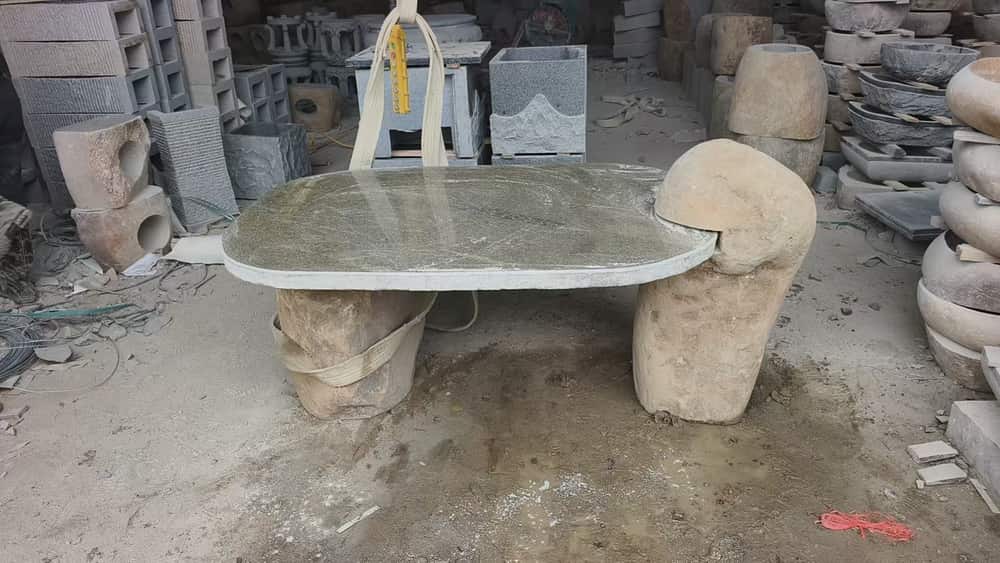 Rectangular outdoor stone table with matching cylindrical stone stools